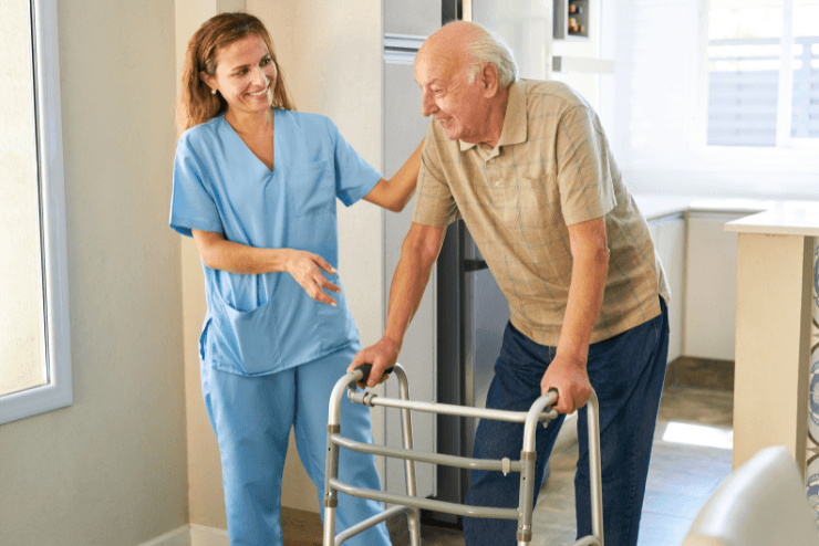 Caregiver helping an elderly with Parkinson