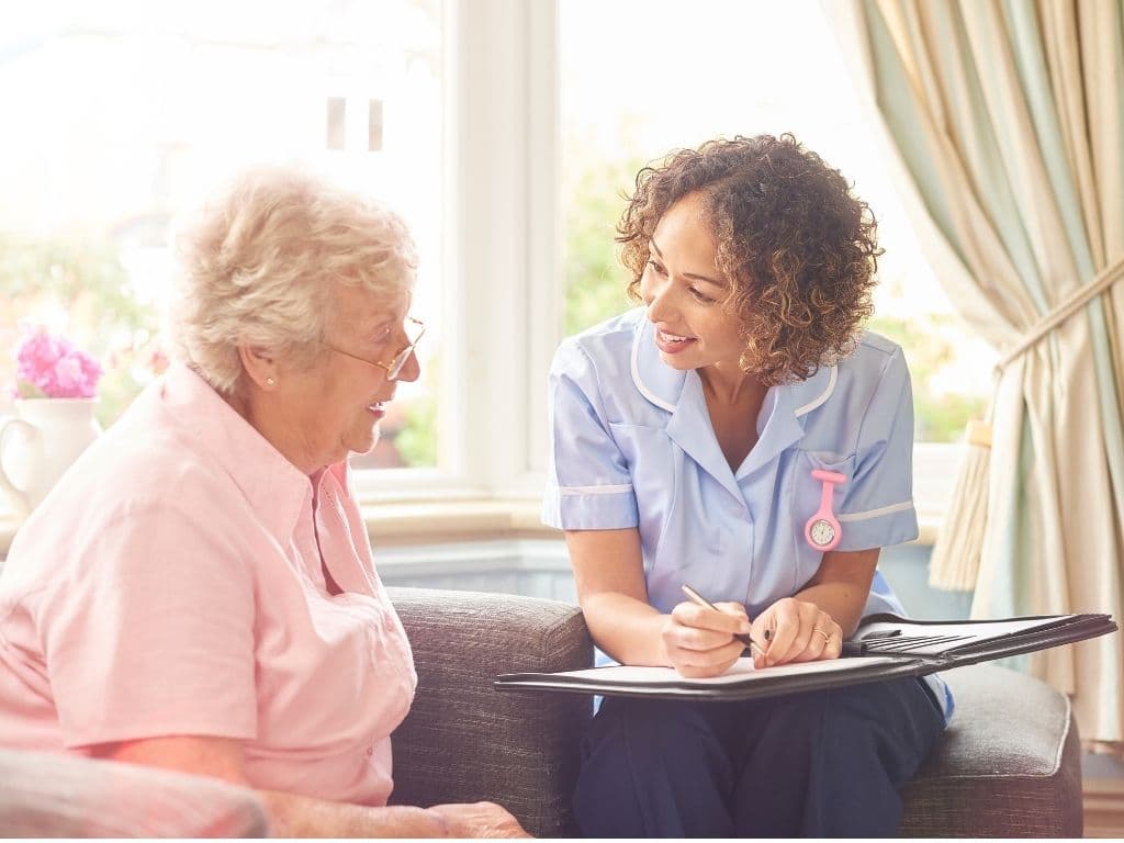 A care coordinator talking through a care plan with an older client at home