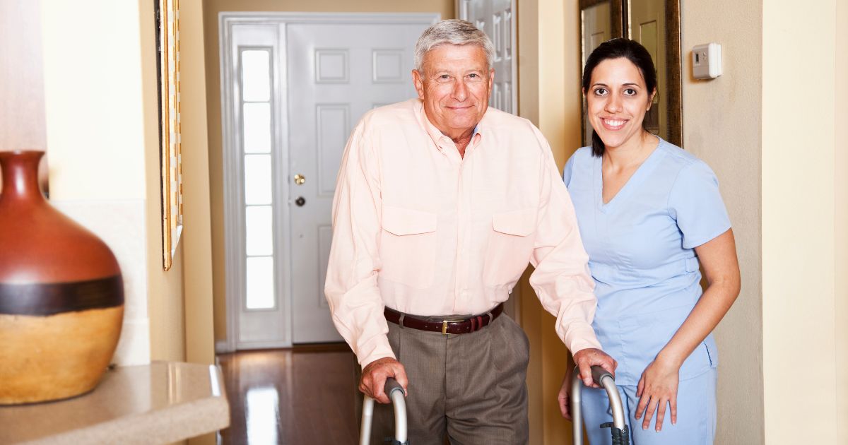 caregiver assisting elderly man