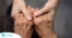 Younger hands hold older ones, representing the care and compassion of caregiving and how caregivers can help, even in ways like implementing stroke prevention strategies.